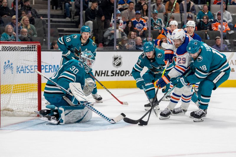 Dec 28, 2023; San Jose, California, USA; Edmonton Oilers center Leon Draisaitl (29) shoots and scores a goal against San Jose Sharks right wing Filip Zadina (18) and San Jose Sharks goalie Magnus Chrona (30) during the first period at SAP Center at San Jose. Mandatory Credit: Neville E. Guard-USA TODAY Sports