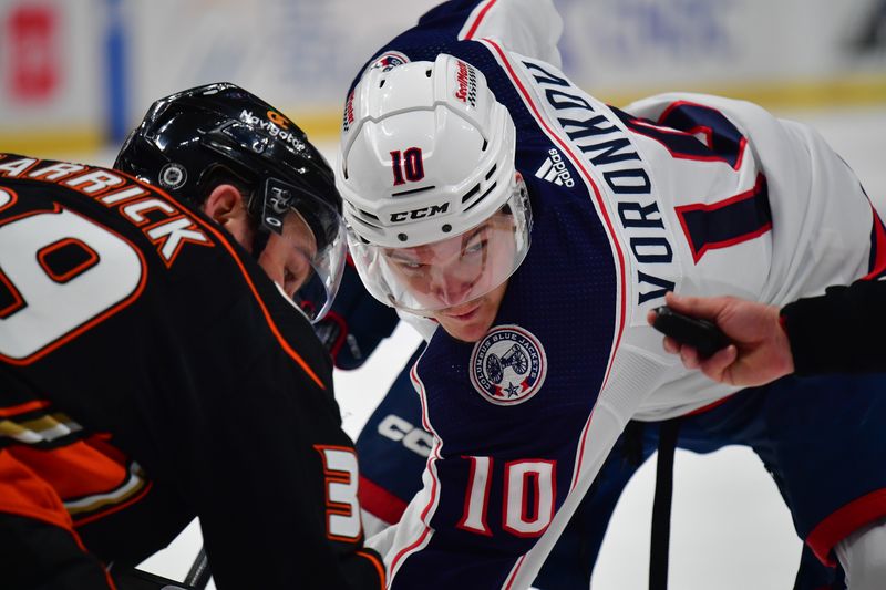 Feb 21, 2024; Anaheim, California, USA; Columbus Blue Jackets left wing Dmitri Voronkov (10) takes the face off against Anaheim Ducks center Sam Carrick (39) during the second period at Honda Center. Mandatory Credit: Gary A. Vasquez-USA TODAY Sports