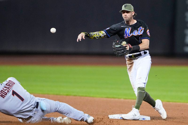 May 21, 2023; New York City, New York, USA; New York Mets second baseman Jeff McNeil (1) turns a double play against the Cleveland Guardians during the ninth inning at Citi Field. Mandatory Credit: Gregory Fisher-USA TODAY Sports