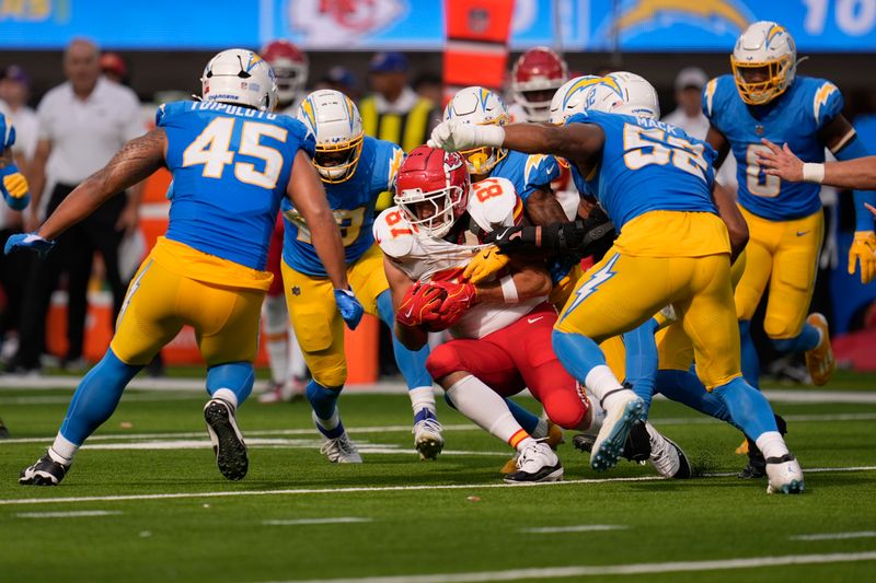 Kansas City Chiefs tight end Travis Kelce (87) catches a pass as a host of Los Angeles Chargers defend during the second half of an NFL football game Sunday, Sept. 29, 2024, in Inglewood, Calif. (AP Photo/Marcio Jose Sanchez)