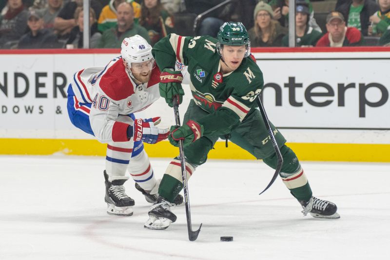 Dec 21, 2023; Saint Paul, Minnesota, USA; Minnesota Wild center Marco Rossi (23) is wrapped up by Montreal Canadiens right wing Joel Armia (40) in the first period at Xcel Energy Center. Mandatory Credit: Matt Blewett-USA TODAY Sports