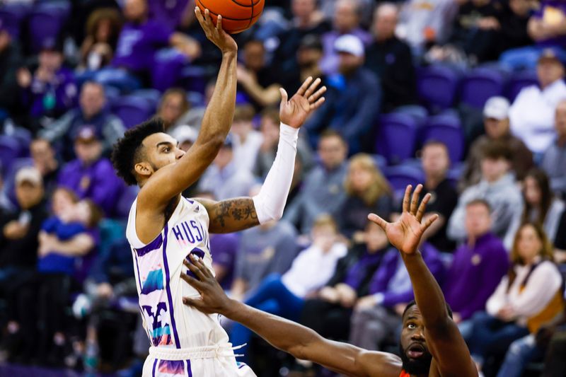 Feb 18, 2023; Seattle, Washington, USA; Washington Huskies guard Jamal Bey (5) shoots against Oregon State Beavers forward Rodrigue Andela (34) during the second half at Alaska Airlines Arena at Hec Edmundson Pavilion. Mandatory Credit: Joe Nicholson-USA TODAY Sports