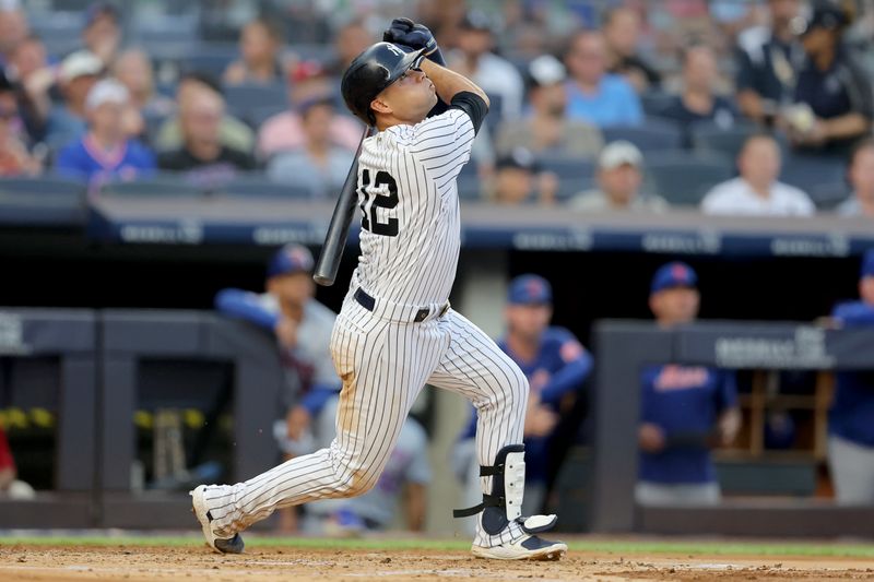 Jul 26, 2023; Bronx, New York, USA; New York Yankees left fielder Isiah Kiner-Falefa (12) follows through on an RBI sacrifice fly against the New York Mets during the second inning at Yankee Stadium. Mandatory Credit: Brad Penner-USA TODAY Sports