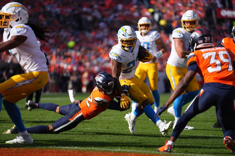 Los Angeles Chargers quarterback Easton Stick (2) runs for a touchdown in the 2nd quarter against the Denver Broncos of an NFL football game Sunday October 13, 2024, in Denver. (AP Photo/Bart Young)