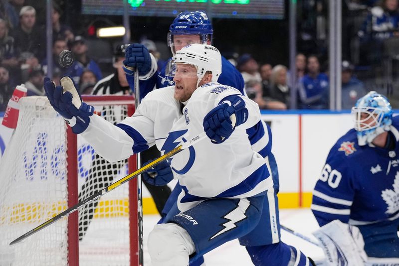 Nov 6, 2023; Toronto, Ontario, CAN; Tampa Bay Lightning forward Steven Stamkos (91) goes to catch a puck against the Toronto Maple Leafs during the second period at Scotiabank Arena. Mandatory Credit: John E. Sokolowski-USA TODAY Sports