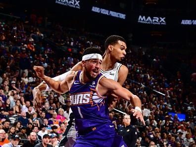 PHOENIX, AZ - NOVEMBER 2: Devin Booker #1 of the Phoenix Suns and Victor Wembanyama #1 of the San Antonio Spurs looks on during the game on November 2, 2023 at Footprint Center in Phoenix, Arizona. NOTE TO USER: User expressly acknowledges and agrees that, by downloading and or using this photograph, user is consenting to the terms and conditions of the Getty Images License Agreement. Mandatory Copyright Notice: Copyright 2023 NBAE (Photo by Barry Gossage/NBAE via Getty Images)