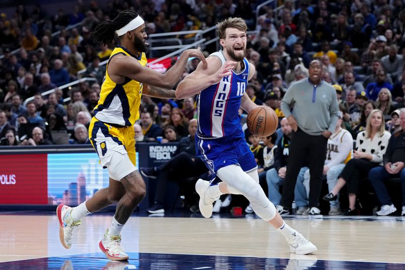 INDIANAPOLIS, INDIANA - FEBRUARY 02: Domantas Sabonis #10 of the Sacramento Kings dribbles the ball while being guarded by Isaiah Jackson #22 of the Indiana Pacers in the first quarter at Gainbridge Fieldhouse on February 02, 2024 in Indianapolis, Indiana. NOTE TO USER: User expressly acknowledges and agrees that, by downloading and or using this photograph, User is consenting to the terms and conditions of the Getty Images License Agreement. (Photo by Dylan Buell/Getty Images)