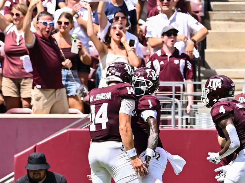 Sep 23, 2023; College Station, Texas, USA; Texas A&M Aggies quarterback Max Johnson (14) congratulates wide receiver Evan Stewart (1) on his touchdown during the third quarter against the Auburn Tigers at Kyle Field. Mandatory Credit: Maria Lysaker-USA TODAY Sports