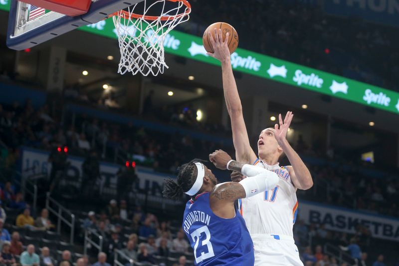 OKLAHOMA CITY, OKLAHOMA - OCTOBER 25: Aleksej Pokusevski #17 of the Oklahoma City Thunder drives to the basket against Robert Covington #23 of the Los Angeles Clippers  during the third quarter at Paycom Center on October 25, 2022 in Oklahoma City, Oklahoma. NOTE TO USER: User expressly acknowledges and agrees that, by downloading and or using this photograph, User is consenting to the terms and conditions of the Getty Images License Agreement.  (Photo by Ian Maule/Getty Images)