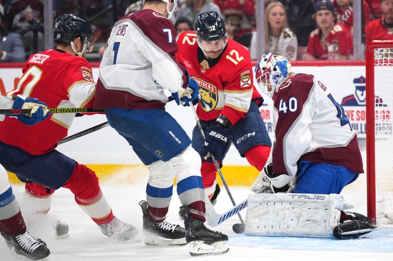 Nov 23, 2024; Sunrise, Florida, USA;  Colorado Avalanche goaltender Alexandar Georgiev (40) makes a save as Florida Panthers left wing Jonah Gadjovich (12) closes in during the second period at Amerant Bank Arena. Mandatory Credit: Jim Rassol-Imagn Images