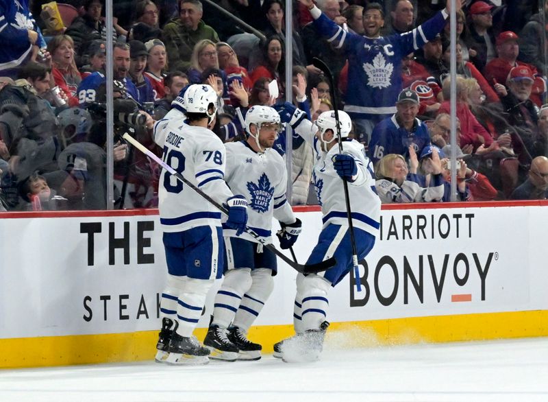 Mar 9, 2024; Montreal, Quebec, CAN; Toronto Maple Leafs forward Max Domi (11) celebrates with teammates after scoring a goal against the Montreal Canadiens during the second period at the Bell Centre. Mandatory Credit: Eric Bolte-USA TODAY Sports