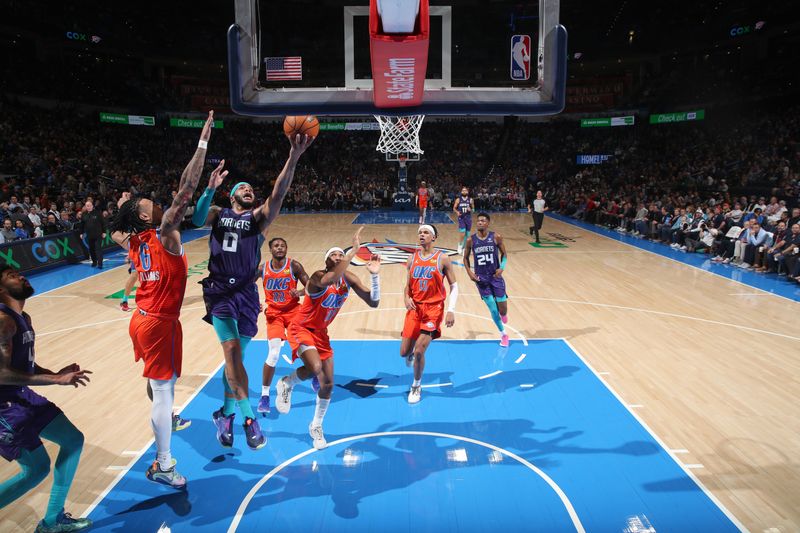 OKLAHOMA CITY, OK - FEBUARY 2:  Miles Bridges #0 of the Charlotte Hornets goes to the basket during the game on February 2, 2024 at Paycom Arena in Oklahoma City, Oklahoma. NOTE TO USER: User expressly acknowledges and agrees that, by downloading and or using this photograph, User is consenting to the terms and conditions of the Getty Images License Agreement. Mandatory Copyright Notice: Copyright 2024 NBAE (Photo by Zach Beeker/NBAE via Getty Images)