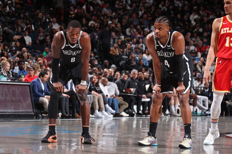 BROOKLYN, NY - MARCH 2: Lonnie Walker IV #8 and Dennis Smith Jr. #4 of the Brooklyn Nets look on during the game against the Atlanta Hawks on March 2, 2024 at Barclays Center in Brooklyn, New York. NOTE TO USER: User expressly acknowledges and agrees that, by downloading and or using this Photograph, user is consenting to the terms and conditions of the Getty Images License Agreement. Mandatory Copyright Notice: Copyright 2024 NBAE (Photo by Nathaniel S. Butler/NBAE via Getty Images)