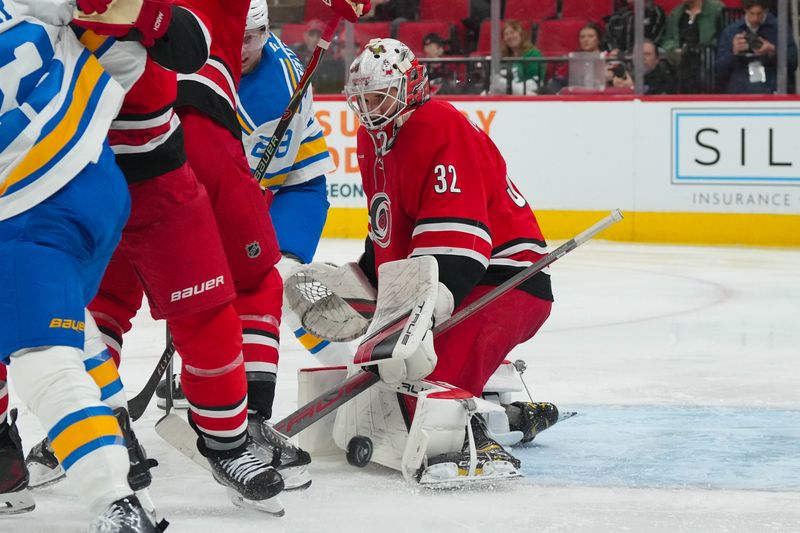 Mar 12, 2026; Raleigh, North Carolina, USA;  Carolina Hurricanes goaltender Brandon Bussi (32) stops the shot against the St. Louis Blues during the second period at Lenovo Center. Mandatory Credit: James Guillory-Imagn Images