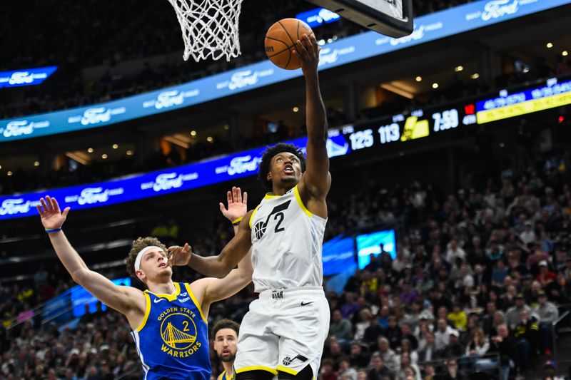 SALT LAKE CITY, UTAH - FEBRUARY 15: Collin Sexton #2 of the Utah Jazz shoots over Brandin Podziemski #2 of the Golden State Warriors during the second half of a game at Delta Center on February 15, 2024 in Salt Lake City, Utah. NOTE TO USER: User expressly acknowledges and agrees that, by downloading and or using this photograph, User is consenting to the terms and conditions of the Getty Images License Agreement. (Photo by Alex Goodlett/Getty Images)