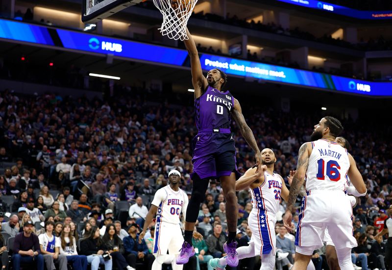 SACRAMENTO, CALIFORNIA - JANUARY 01: Malik Monk #0 of the Sacramento Kings drives to the basket for a layup against the Philadelphia 76ers during the first half of an NBA basketball game at Golden 1 Center on January 01, 2025 in Sacramento, California. NOTE TO USER: User expressly acknowledges and agrees that, by downloading and or using this photograph, User is consenting to the terms and conditions of the Getty Images License Agreement. (Photo by Thearon W. Henderson/Getty Images)