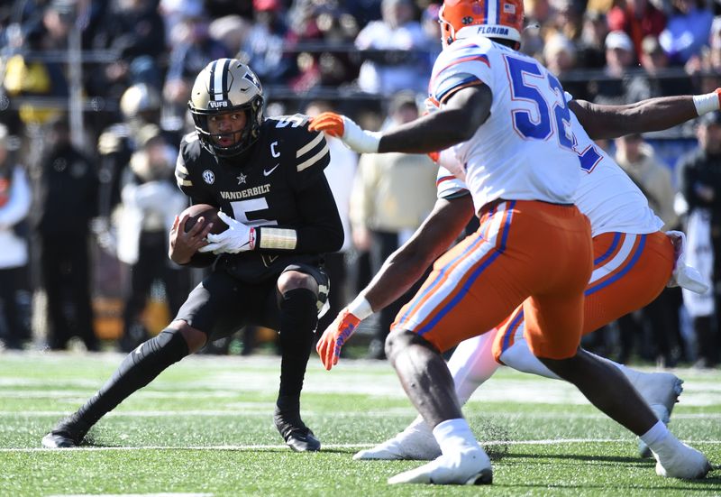 Nov 19, 2022; Nashville, Tennessee, USA; Vanderbilt Commodores quarterback Mike Wright (5) runs for a short gain during the first half against the Florida Gators at FirstBank Stadium. Mandatory Credit: Christopher Hanewinckel-USA TODAY Sports