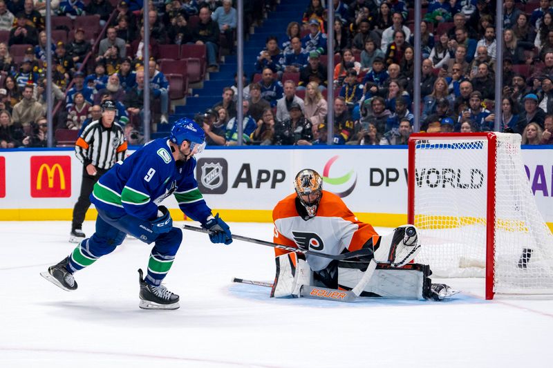 Oct 11, 2024; Vancouver, British Columbia, CAN; Philadelphia Flyers goalie Samuel Ersson (33) makes a save on Vancouver Canucks forward J.T. Miller (9) in the shootout at Rogers Arena. Mandatory Credit: Bob Frid-Imagn Images