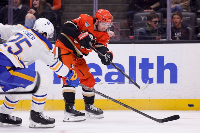 Nov 22, 2024; Anaheim, California, USA; Anaheim Ducks right wing Frank Vatrano (77) passes ahead of Buffalo Sabres defenseman Owen Power (25) during the second period at Honda Center. Mandatory Credit: Ryan Sun-Imagn Images