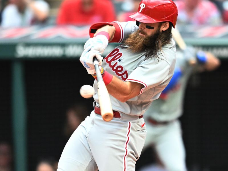 Jul 23, 2023; Cleveland, Ohio, USA; Philadelphia Phillies center fielder Brandon Marsh (16) hits a triple during the fifth inning against the Cleveland Guardians at Progressive Field. Mandatory Credit: Ken Blaze-USA TODAY Sports