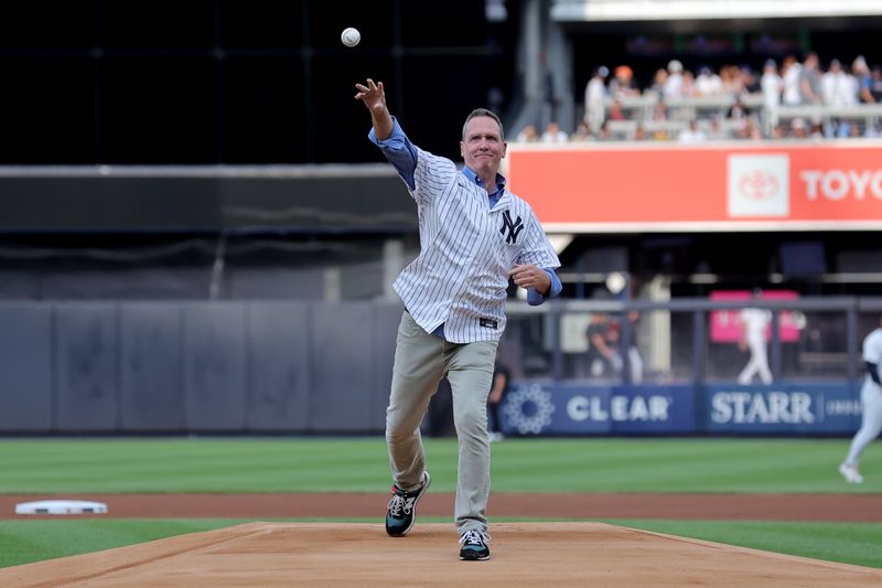 Jul 23, 2024; Bronx, New York, USA; New York Mets and New York Yankees former pitcher David Cone throws a ceremonial first pitch before a subway series game between the two teams at Yankee Stadium. Mandatory Credit: Brad Penner-USA TODAY Sports