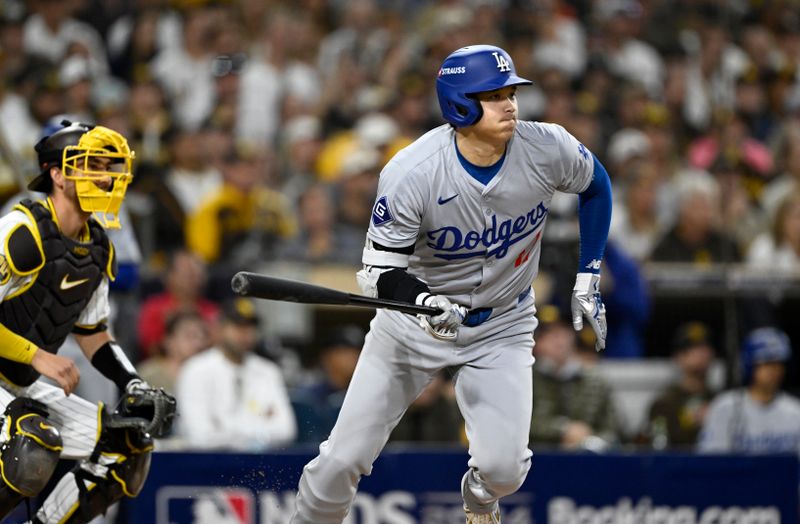 Oct 9, 2024; San Diego, California, USA; Los Angeles Dodgers designated hitter Shohei Ohtani (17) hits a RBI single in the second inning against the San Diego Padres during game four of the NLDS for the 2024 MLB Playoffs at Petco Park.  Mandatory Credit: Denis Poroy-Imagn Images