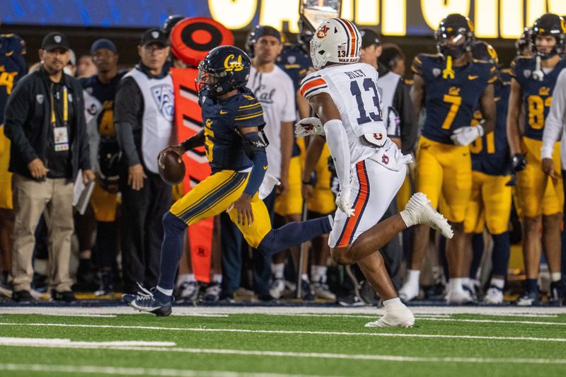 Sep 9, 2023; Berkeley, California, USA; California Golden Bears quarterback Sam Jackson V (5) rushes with the football against Auburn Tigers linebacker Cam Riley (13) during the second quarter at California Memorial Stadium. Mandatory Credit: Neville E. Guard-USA TODAY Sports