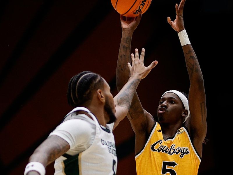 Feb 15, 2025; Fort Collins, Colorado, USA; Wyoming Cowboys guard Obi Agbim (5) attempts a shot against Colorado State Rams forward Jaylen Crocker-Johnson (8) in the first half at Moby Arena. Mandatory Credit: Isaiah J. Downing-Imagn Images