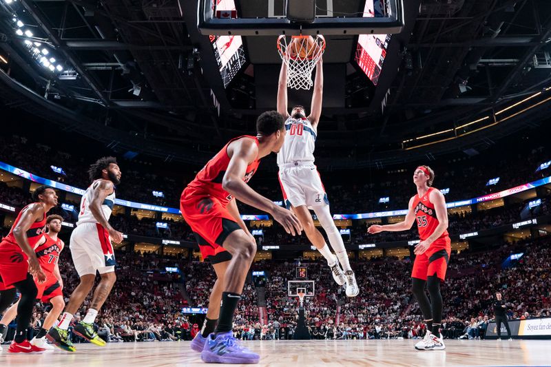 MONTREAL, CANADA - OCTOBER 6: Tristan Vukcevic #00 of the Washington Wizards dunks the ball during the game against the Toronto Raptors on October 6, 2024 at the Bell Centre in Montreal, Quebec, Canada.  NOTE TO USER: User expressly acknowledges and agrees that, by downloading and or using this Photograph, user is consenting to the terms and conditions of the Getty Images License Agreement.  Mandatory Copyright Notice: Copyright 2024 NBAE (Photo by Jordan Jones/NBAE via Getty Images)