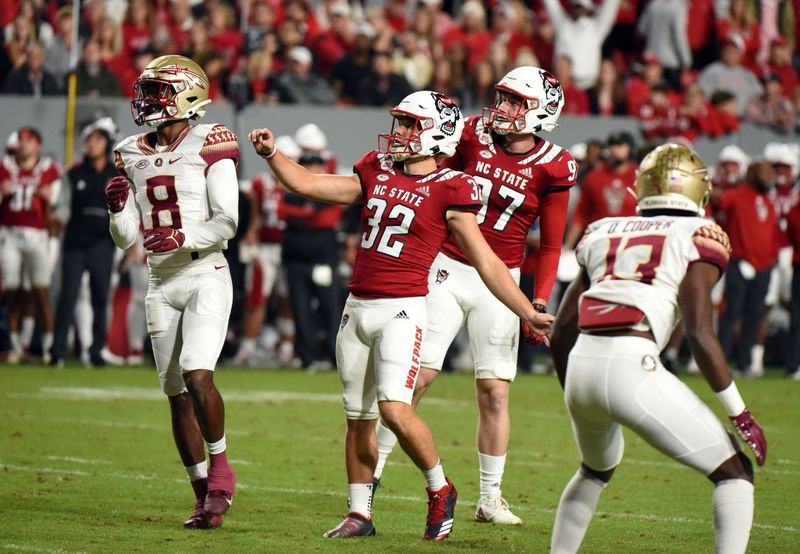 Oct 8, 2022; Raleigh, North Carolina, USA;North Carolina State Wolfpack kicker Christopher Dunn (32) watches his kick go through the uprights during the first half against the Florida State Seminoles at Carter-Finley Stadium. Mandatory Credit: Rob Kinnan-USA TODAY Sports