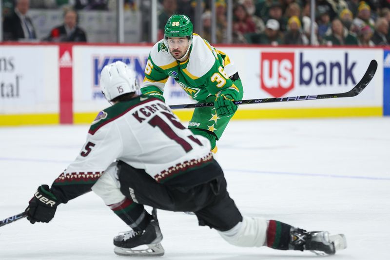 Jan 13, 2024; Saint Paul, Minnesota, USA; Minnesota Wild right wing Mats Zuccarello (36) passes as Arizona Coyotes center Alexander Kerfoot (15) during the second period at Xcel Energy Center. Mandatory Credit: Matt Krohn-USA TODAY Sports