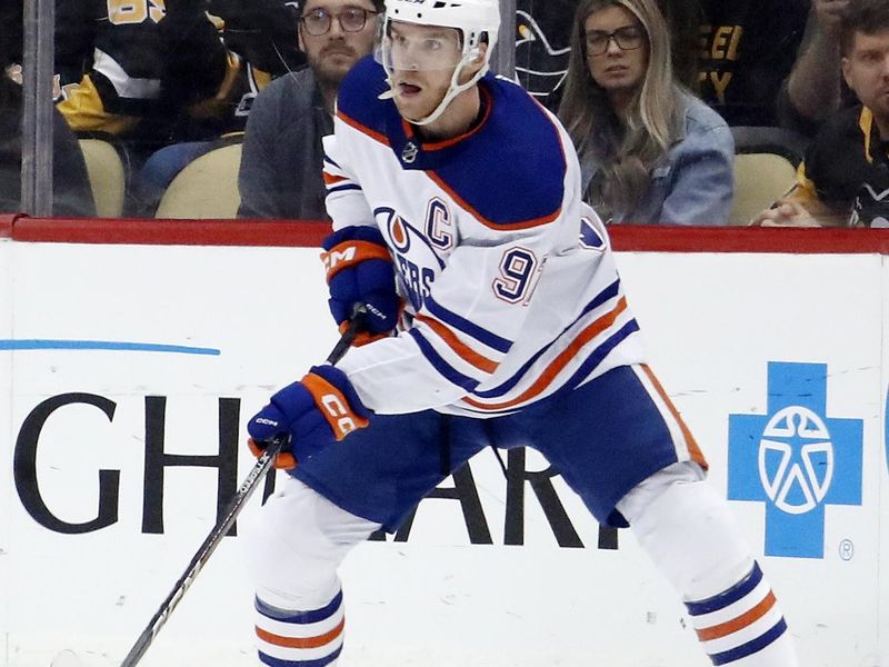 Feb 23, 2023; Pittsburgh, Pennsylvania, USA; Edmonton Oilers center Connor McDavid (97) handles the puck  against the Pittsburgh Penguins during the first period at PPG Paints Arena. Mandatory Credit: Charles LeClaire-USA TODAY Sports