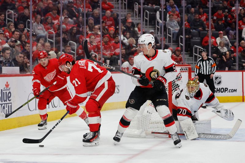 Jan 31, 2024; Detroit, Michigan, USA;  Detroit Red Wings center Dylan Larkin (71) skates with the puck defended by Ottawa Senators center Shane Pinto (57) in the second period at Little Caesars Arena. Mandatory Credit: Rick Osentoski-USA TODAY Sports