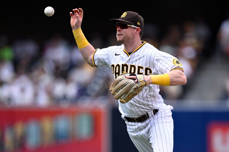 Aug 19, 2023; San Diego, California, USA; San Diego Padres second baseman Jake Cronenworth (9) cannot handle the ball on a single hit by Arizona Diamondbacks center fielder Alek Thomas (not pictured) during the sixth inning at Petco Park. Mandatory Credit: Orlando Ramirez-USA TODAY Sports