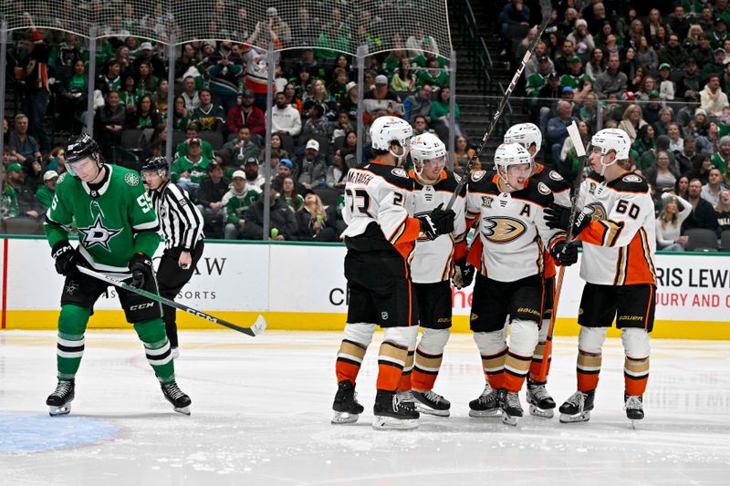 Jan 25, 2024; Dallas, Texas, USA; Anaheim Ducks center Mason McTavish (23) and center Isac Lundestrom (21) and defenseman Cam Fowler (4) and right wing Jakob Silfverberg (33) and defenseman Jackson LaCombe (60) celebrates a goal scored by Silfverberg against the Dallas Stars during the third period at the American Airlines Center. Mandatory Credit: Jerome Miron-USA TODAY Sports