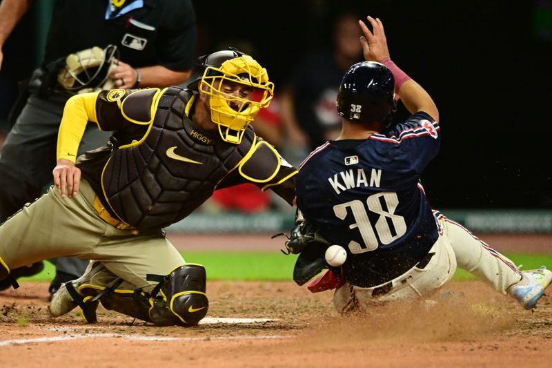 Jul 19, 2024; Cleveland, Ohio, USA; Cleveland Guardians left fielder Steven Kwan (38) slides into home as San Diego Padres catcher Kyle Higashioka (20) loses the ball during the eighth inning at Progressive Field. Mandatory Credit: Ken Blaze-USA TODAY Sports