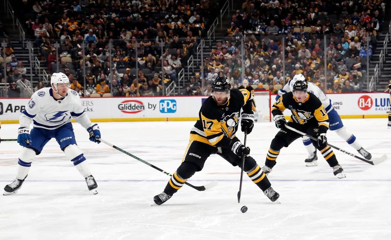 Apr 6, 2024; Pittsburgh, Pennsylvania, USA;  Pittsburgh Penguins right wing Bryan Rust (17) skates with the puck against the Tampa Bay Lightning during the third period at PPG Paints Arena. The Penguins won 5-4. Mandatory Credit: Charles LeClaire-USA TODAY Sports