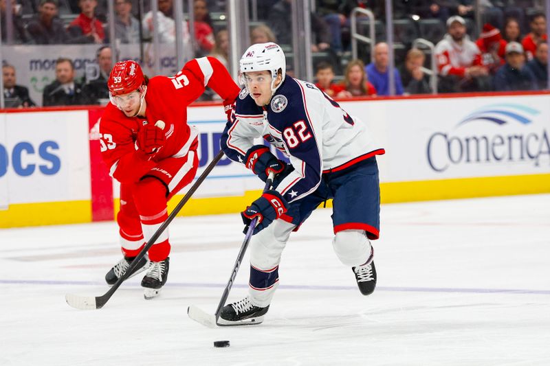 Mar 19, 2024; Detroit, Michigan, USA; Columbus Blue Jackets left wing Mikael Pyyhtia (82) handles the puck during the first period of the game against the Detroit Red Wings at Little Caesars Arena. Mandatory Credit: Brian Bradshaw Sevald-USA TODAY Sports