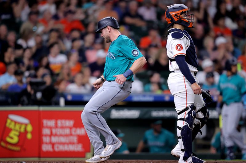 May 5, 2024; Houston, Texas, USA; Seattle Mariners right fielder Luke Raley (20) crosses home plate to score a run against the Houston Astros during the second inning at Minute Maid Park. Mandatory Credit: Erik Williams-USA TODAY Sports