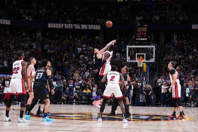 DENVER, CO - FEBRUARY 29: Nikola Jokic #15 of the Denver Nuggets and Bam Adebayo #13 of the Miami Heat go up for the opening tip off on February 29, 2024 at the Ball Arena in Denver, Colorado. NOTE TO USER: User expressly acknowledges and agrees that, by downloading and/or using this Photograph, user is consenting to the terms and conditions of the Getty Images License Agreement. Mandatory Copyright Notice: Copyright 2024 NBAE (Photo by Garrett Ellwood/NBAE via Getty Images)