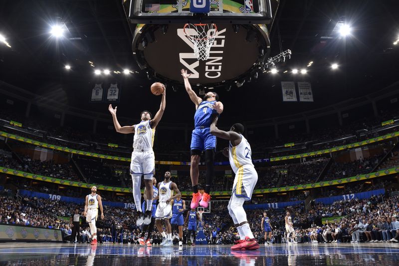 ORLANDO, FL - MARCH 27: Trayce Jackson-Davis #32 of the Golden State Warriors  rebounds the ball during the game against the Orlando Magic on March 27, 2024 at Amway Center in Orlando, Florida. NOTE TO USER: User expressly acknowledges and agrees that, by downloading and or using this photograph, User is consenting to the terms and conditions of the Getty Images License Agreement. Mandatory Copyright Notice: Copyright 2024 NBAE (Photo by Fernando Medina/NBAE via Getty Images)