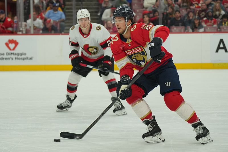 Feb 20, 2024; Sunrise, Florida, USA; Florida Panthers defenseman Brandon Montour (62) brings the puck up the ice as Ottawa Senators left wing Parker Kelly (27) follows on the play during the first period at Amerant Bank Arena. Mandatory Credit: Jim Rassol-USA TODAY Sports