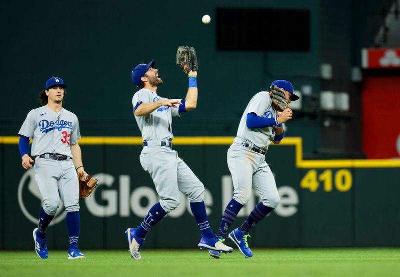 Jul 23, 2023; Arlington, Texas, USA;  Los Angeles Dodgers left fielder Chris Taylor (3) makes a catch in front of Los Angeles Dodgers shortstop Miguel Rojas (11) and Los Angeles Dodgers center fielder James Outman (33) during the third inning against the Texas Rangers at Globe Life Field. Mandatory Credit: Kevin Jairaj-USA TODAY Sports