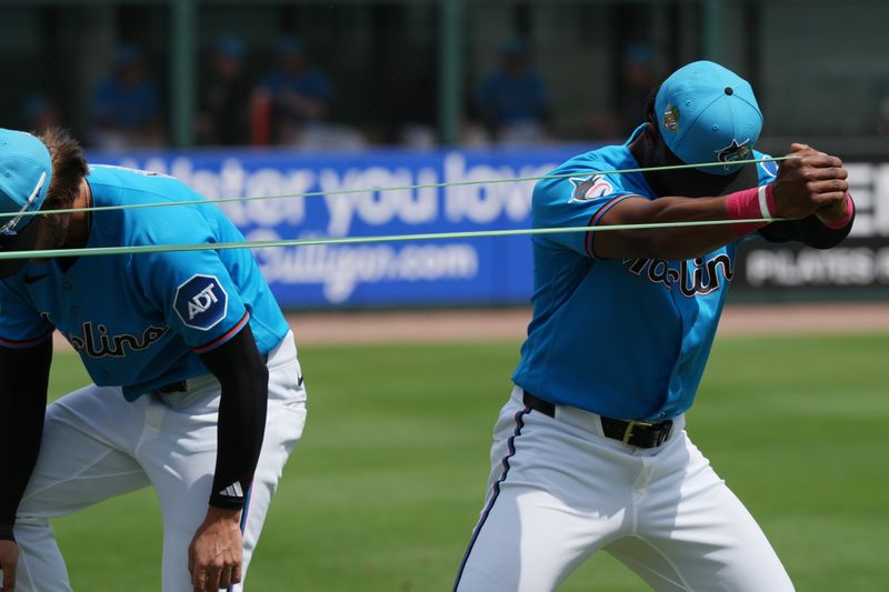 Mar 16, 2026; Jupiter, Florida, USA;  Miami Marlins shortstop Otto Lopez (6) stretches his arms before the game against the Toronto Blue Jays at Roger Dean Chevrolet Stadium. Mandatory Credit: Jim Rassol-Imagn Images