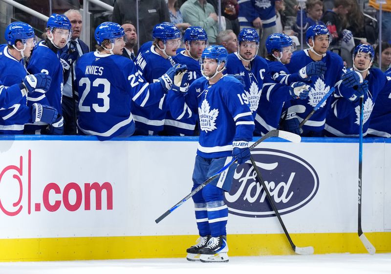 Oct 8, 2025; Toronto, Ontario, CAN; Toronto Maple Leafs center Calle Jarnkrok (19) celebrates at the bench after scoring a goal against the Montreal Canadiens during the second period at Scotiabank Arena. Mandatory Credit: Nick Turchiaro-Imagn Images