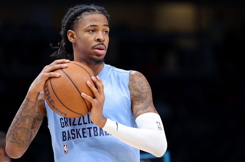 ATLANTA, GEORGIA - DECEMBER 23:  Ja Morant #12 of the Memphis Grizzlies warms up prior to facing the Atlanta Hawks at State Farm Arena on December 23, 2023 in Atlanta, Georgia.  NOTE TO USER: User expressly acknowledges and agrees that, by downloading and/or using this photograph, user is consenting to the terms and conditions of the Getty Images License Agreement.  (Photo by Kevin C. Cox/Getty Images)