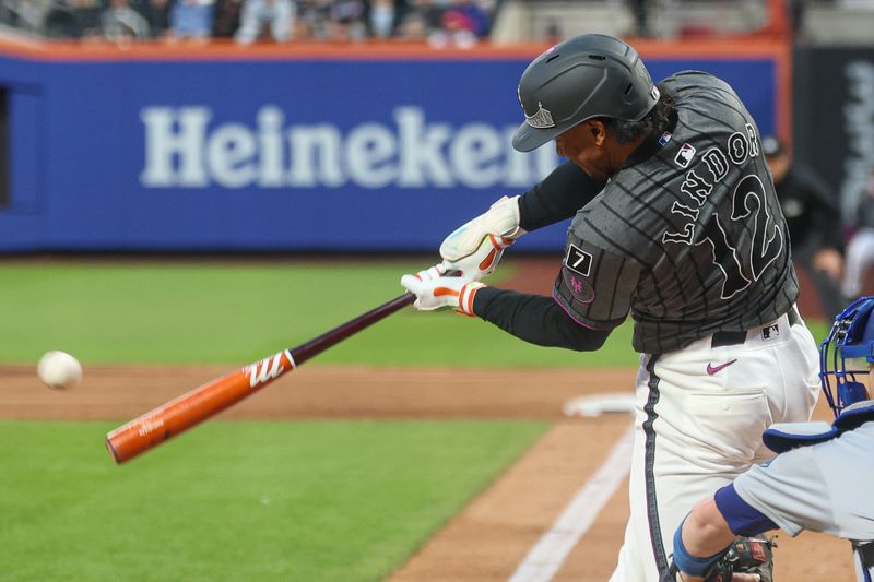 May 25, 2025; New York City, New York, USA; New York Mets shortstop Francisco Lindor (12) singles during the third inning against the Los Angeles Dodgers at Citi Field. Mandatory Credit: Vincent Carchietta-Imagn Images