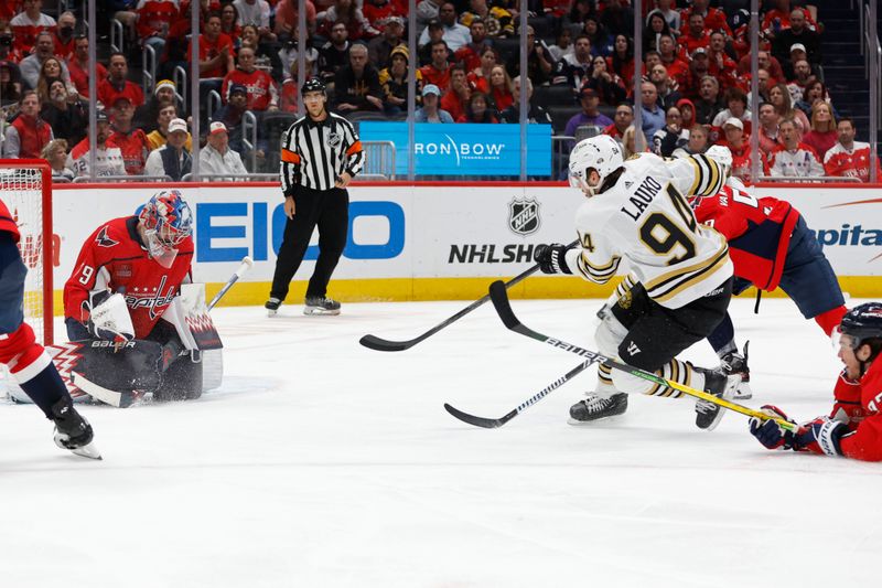 Apr 15, 2024; Washington, District of Columbia, USA; Washington Capitals goaltender Charlie Lindgren (79) makes a save on Boston Bruins center Jakub Lauko (94) in the second period at Capital One Arena. Mandatory Credit: Geoff Burke-USA TODAY Sports