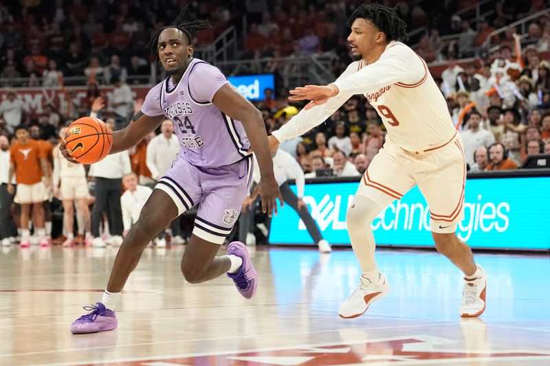 Feb 19, 2024; Austin, Texas, USA; Kansas State Wildcats forward Arthur Kaluma (24) drives to the basket while defended by Texas Longhorns guard Ithiel Horton (9) during the second half at Moody Center. Mandatory Credit: Scott Wachter-USA TODAY Sports