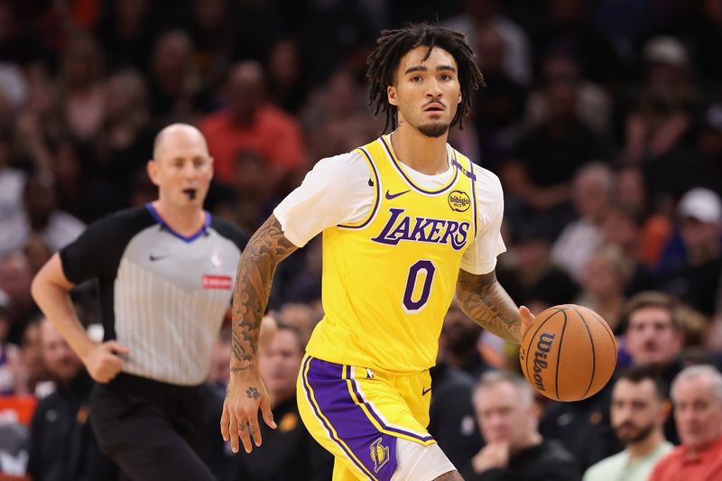 PHOENIX, ARIZONA - OCTOBER 17: Jalen Hood-Schifino #0 of the Los Angeles Lakers handles the ball during the first half of the preseason NBA game against the Phoenix Suns at Footprint Center on October 17, 2024 in Phoenix, Arizona. NOTE TO USER: User expressly acknowledges and agrees that, by downloading and/or using this photograph, user is consenting to the terms and conditions of the Getty Images License Agreement.  (Photo by Christian Petersen/Getty Images)